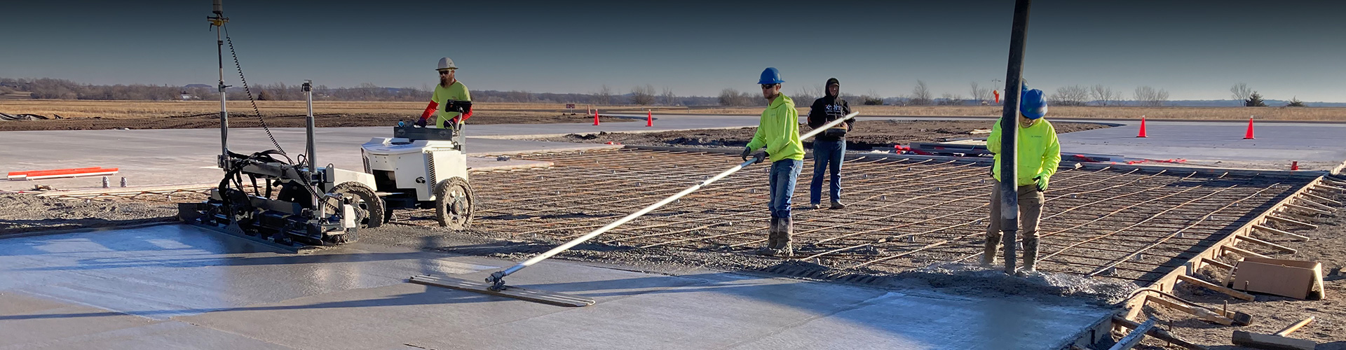 concrete team installing concrete foundation for airplane hangar