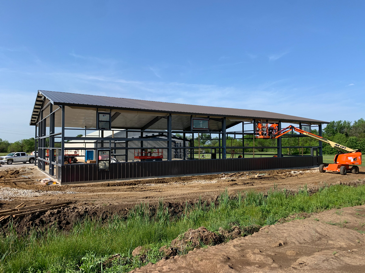 construction team erecting pre-engineered metal building