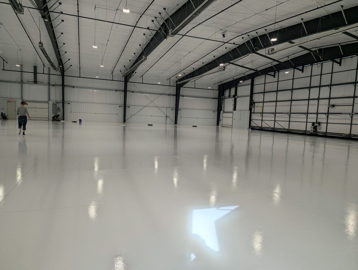 interior of airplane hangar with protective floor coating