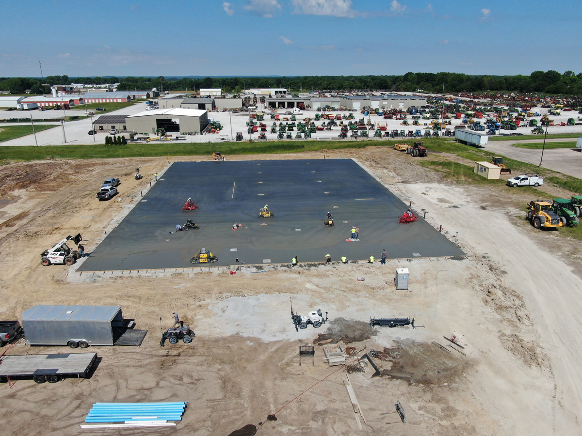 concrete contractors pouring foundation for storage building