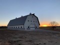 lavender family ranch barn style pre-engineered metal building at sunset