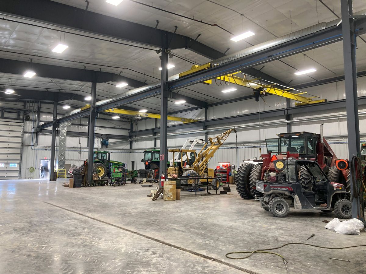 tractor storage building with integrated lifts for maintenance