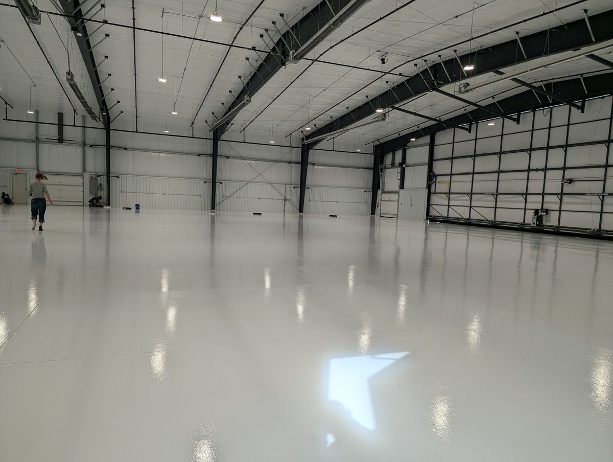 interior of airplane hangar with protective floor coating