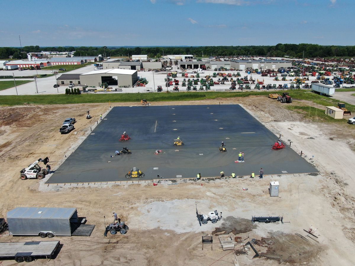 construction team preparing concrete foundation for warehouse